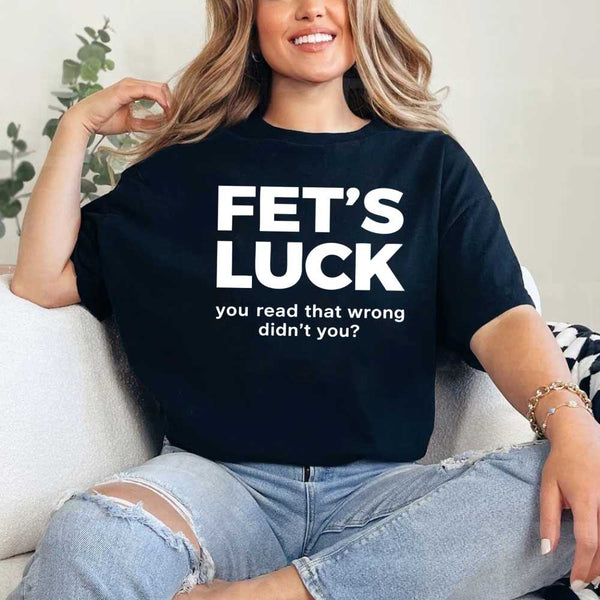 May include a graphic t-shirt featuring the phrase “FET’S LUCK” designed as an optical illusion.