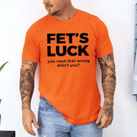 May include a graphic t-shirt featuring the phrase “FET’S LUCK” designed as an optical illusion.