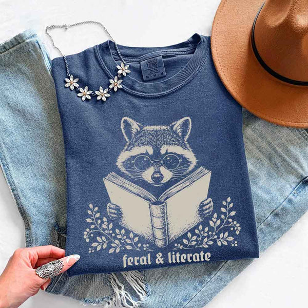 May include Feral & Literate Raccoon Comfort Colors t-shirt with funny book lover graphic, relaxed unisex fit, and garment-dyed cotton