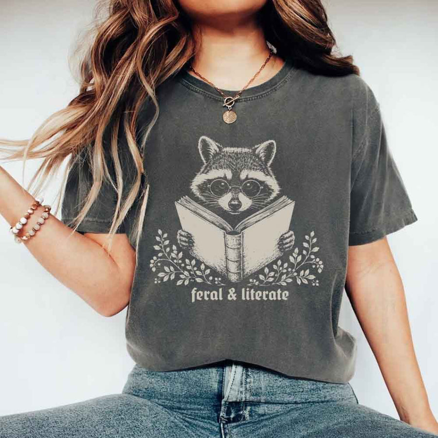 May include Feral & Literate Raccoon Comfort Colors t-shirt with funny book lover graphic, relaxed unisex fit, and garment-dyed cotton