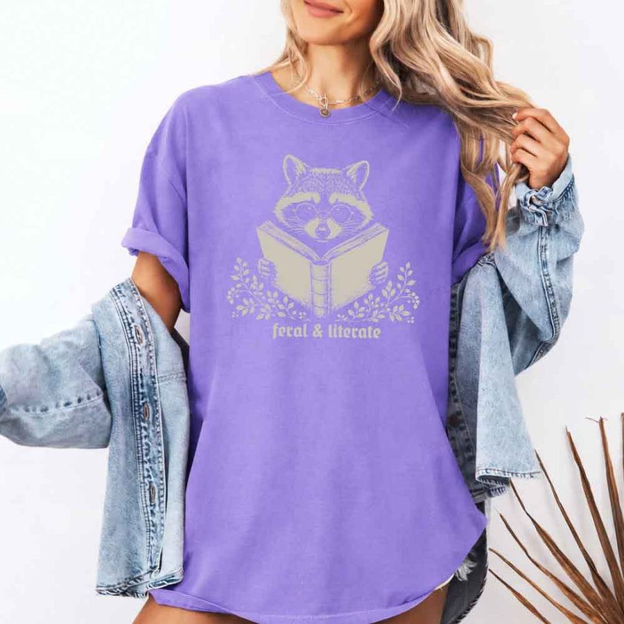 May include Feral & Literate Raccoon Comfort Colors t-shirt with funny book lover graphic, relaxed unisex fit, and garment-dyed cotton