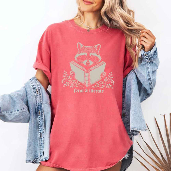 May include Feral & Literate Raccoon Comfort Colors t-shirt with funny book lover graphic, relaxed unisex fit, and garment-dyed cotton