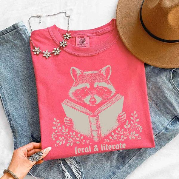 May include Feral & Literate Raccoon Comfort Colors t-shirt with funny book lover graphic, relaxed unisex fit, and garment-dyed cotton