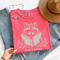 May include Feral & Literate Raccoon Comfort Colors t-shirt with funny book lover graphic, relaxed unisex fit, and garment-dyed cotton