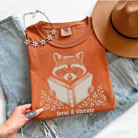 May include Feral & Literate Raccoon Comfort Colors t-shirt with funny book lover graphic, relaxed unisex fit, and garment-dyed cotton