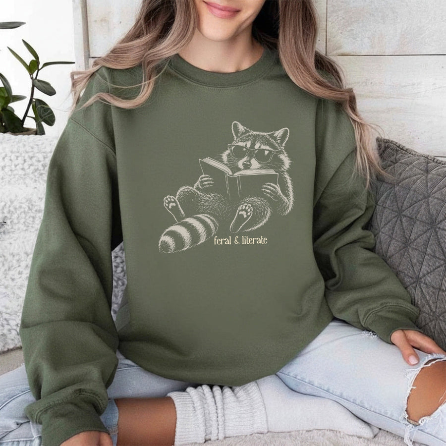 May include a Feral & Literate Raccoon Sweatshirt featuring a playful raccoon illustration and witty book lover statement design.