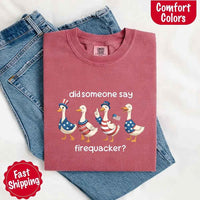 Folded red t-shirt with graphic design and text on a white background