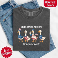 May include a folded pepper Comfort Colors t-shirt featuring a 'Firequacker' goose graphic — a humorous 4th of July design with vintage USA patriotic elements.
