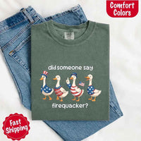 Green t-shirt with graphic design and text on a white background, featuring jeans.
