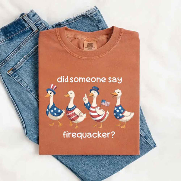 May include a Yam color folded Comfort Colors t-shirt featuring a 'Firequacker' goose graphic — a humorous 4th of July design with vintage USA patriotic elements.
