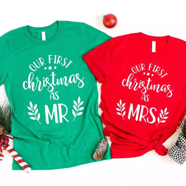 May include matching “First Christmas as Mr. and Mrs.” T-shirts featuring festive holiday graphics and text for newlywed couples.