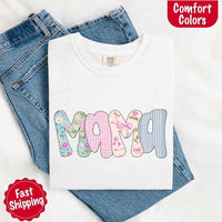 White t-shirt with floral 'MAMA' design on blue jeans, featuring Comfort Colors branding.
