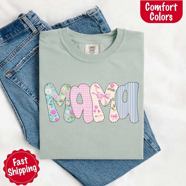 Light blue t-shirt with 'Mama' text in colorful letters on jeans, branded with Comfort Colors.