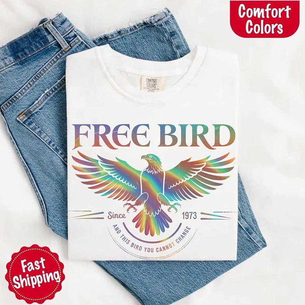 May include a vintage-inspired design with the phrase “Free Bird” on a Comfort Colors tee, channeling classic rock band style and retro music vibes perfect for fans of timeless tunes.