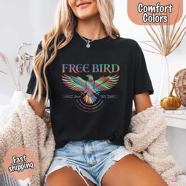 May include a vintage-inspired design with the phrase “Free Bird” on a Comfort Colors tee, channeling classic rock band style and retro music vibes perfect for fans of timeless tunes.