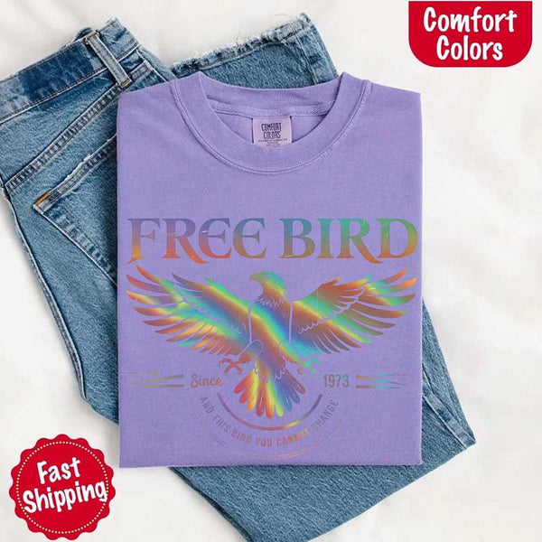May include a vintage-inspired design with the phrase “Free Bird” on a Comfort Colors tee, channeling classic rock band style and retro music vibes perfect for fans of timeless tunes.