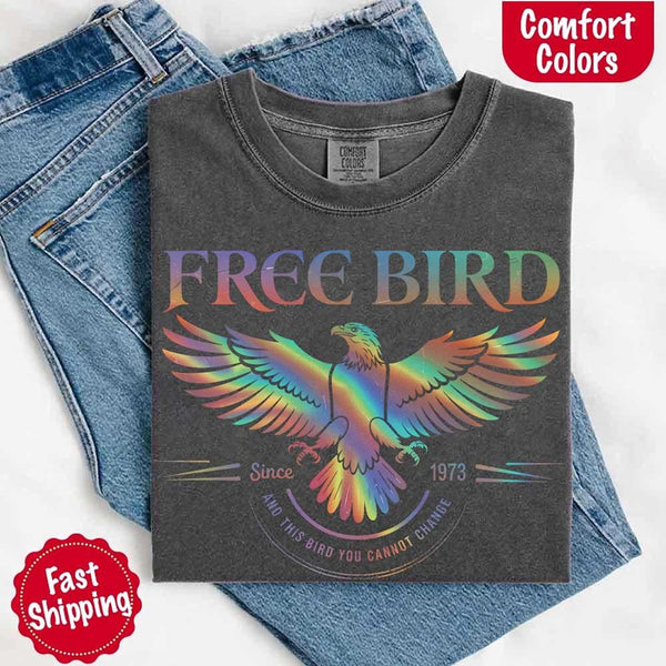 May include a vintage-inspired design with the phrase “Free Bird” on a Comfort Colors tee, channeling classic rock band style and retro music vibes perfect for fans of timeless tunes.