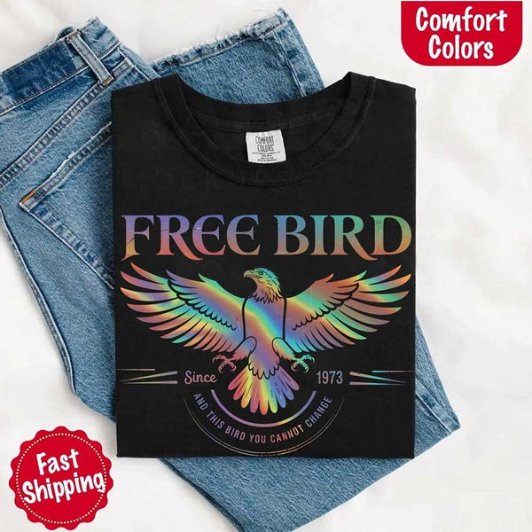 May include a vintage-inspired design with the phrase “Free Bird” on a Comfort Colors tee, channeling classic rock band style and retro music vibes perfect for fans of timeless tunes.