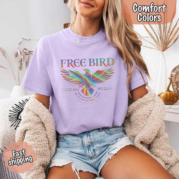 May include a vintage-inspired design with the phrase “Free Bird” on a Comfort Colors tee, channeling classic rock band style and retro music vibes perfect for fans of timeless tunes.