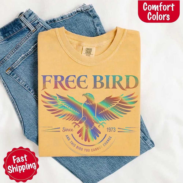 May include a vintage-inspired design with the phrase “Free Bird” on a Comfort Colors tee, channeling classic rock band style and retro music vibes perfect for fans of timeless tunes.