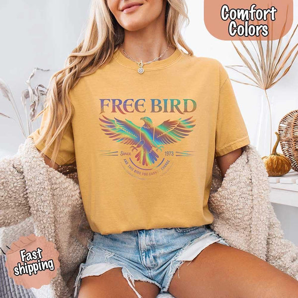 May include a vintage-inspired design with the phrase “Free Bird” on a Comfort Colors tee, channeling classic rock band style and retro music vibes perfect for fans of timeless tunes.