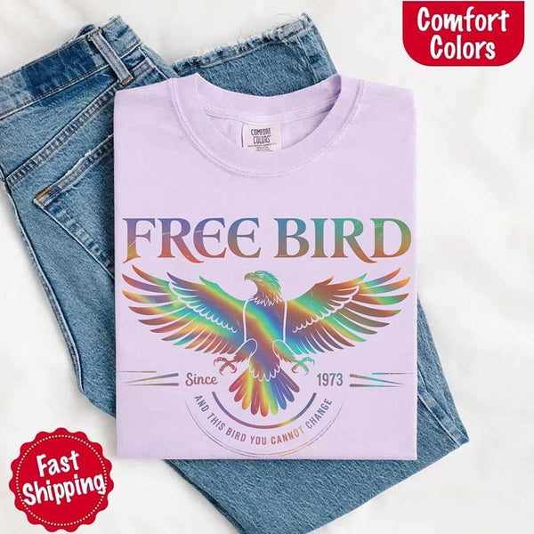 May include a vintage-inspired design with the phrase “Free Bird” on a Comfort Colors tee, channeling classic rock band style and retro music vibes perfect for fans of timeless tunes.