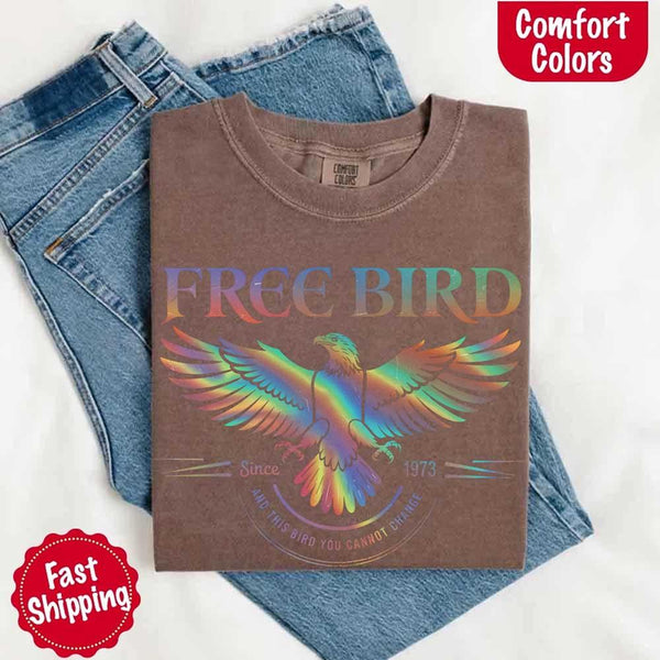 May include a vintage-inspired design with the phrase “Free Bird” on a Comfort Colors tee, channeling classic rock band style and retro music vibes perfect for fans of timeless tunes.