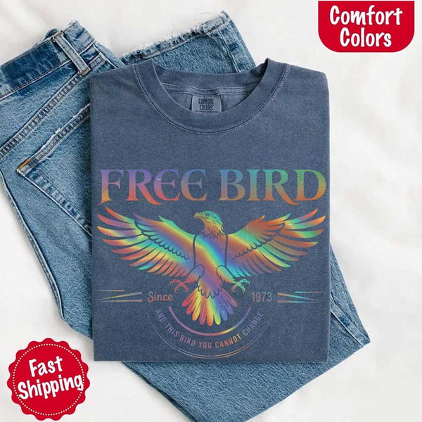 May include a vintage-inspired design with the phrase “Free Bird” on a Comfort Colors tee, channeling classic rock band style and retro music vibes perfect for fans of timeless tunes.