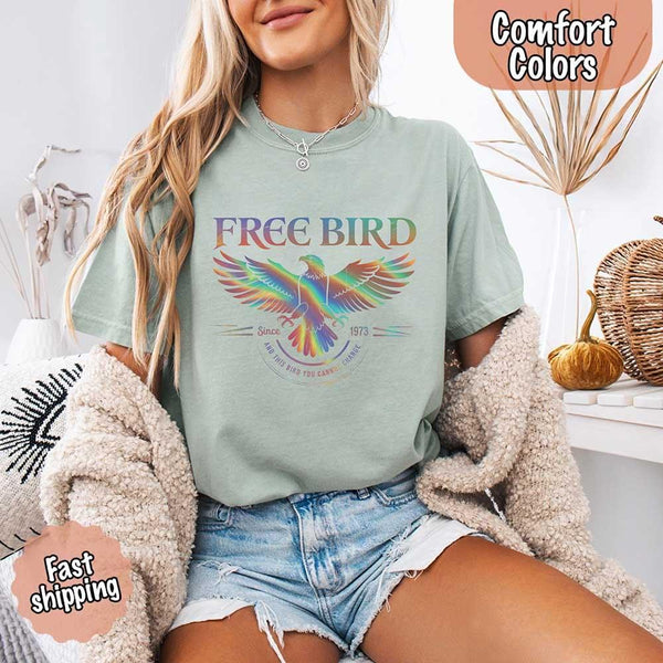 May include a vintage-inspired design with the phrase “Free Bird” on a Comfort Colors tee, channeling classic rock band style and retro music vibes perfect for fans of timeless tunes.