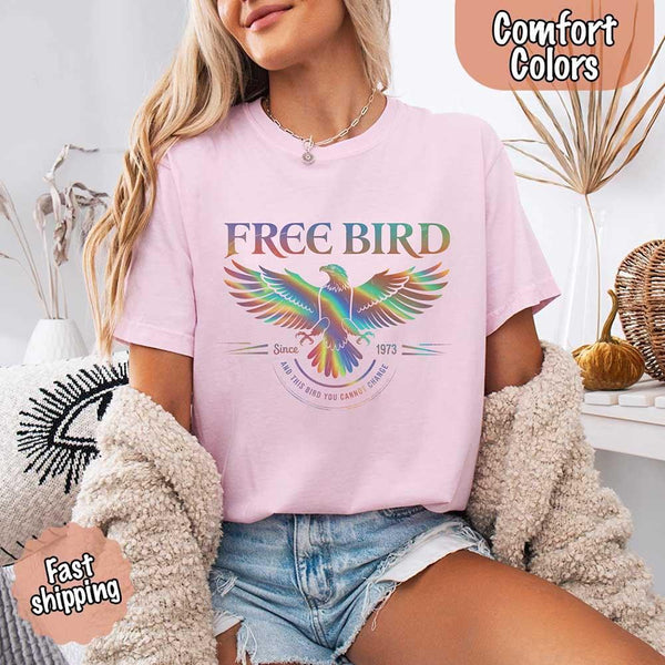May include a vintage-inspired design with the phrase “Free Bird” on a Comfort Colors tee, channeling classic rock band style and retro music vibes perfect for fans of timeless tunes.