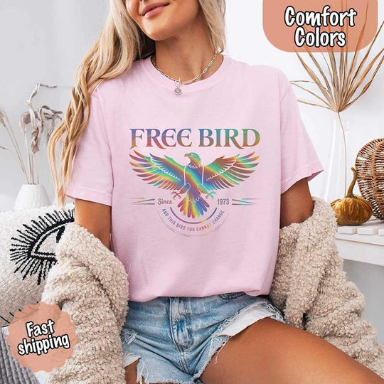 May include a vintage-inspired design with the phrase “Free Bird” on a Comfort Colors tee, channeling classic rock band style and retro music vibes perfect for fans of timeless tunes.