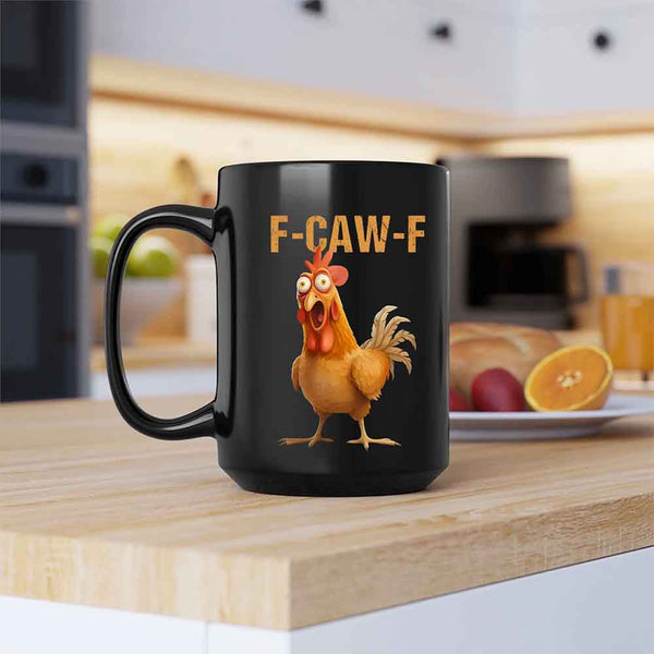 Black mug with a rooster graphic and 'F-CAW-F' text on a kitchen counter.