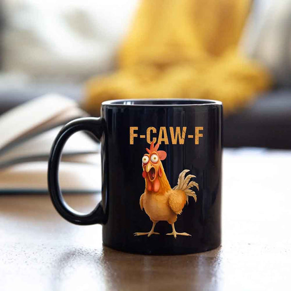 Black mug with a cartoon chicken and 'F-CAW-F' text on a blurred background