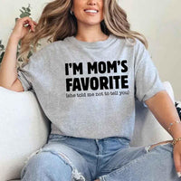 May include a unisex t-shirt reading “I’m Mom’s Favorite” in bold font, displayed on a flat lay or model, ideal for Mother’s Day gifting.