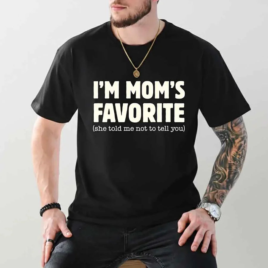 May include a unisex t-shirt reading “I’m Mom’s Favorite” in bold font, displayed on a flat lay or model, ideal for Mother’s Day gifting.