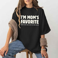 May include a unisex t-shirt reading “I’m Mom’s Favorite” in bold font, displayed on a flat lay or model, ideal for Mother’s Day gifting.