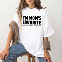 May include a unisex t-shirt reading “I’m Mom’s Favorite” in bold font, displayed on a flat lay or model, ideal for Mother’s Day gifting.