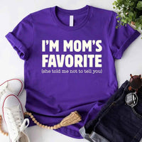 May include a unisex t-shirt reading “I’m Mom’s Favorite” in bold font, displayed on a flat lay or model, ideal for Mother’s Day gifting.