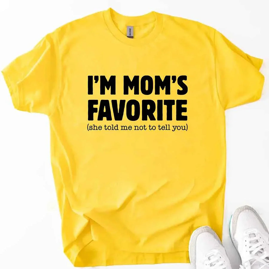 May include a unisex t-shirt reading “I’m Mom’s Favorite” in bold font, displayed on a flat lay or model, ideal for Mother’s Day gifting.