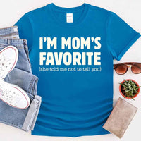 May include a unisex t-shirt reading “I’m Mom’s Favorite” in bold font, displayed on a flat lay or model, ideal for Mother’s Day gifting.