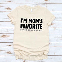 May include a unisex t-shirt reading “I’m Mom’s Favorite” in bold font, displayed on a flat lay or model, ideal for Mother’s Day gifting.