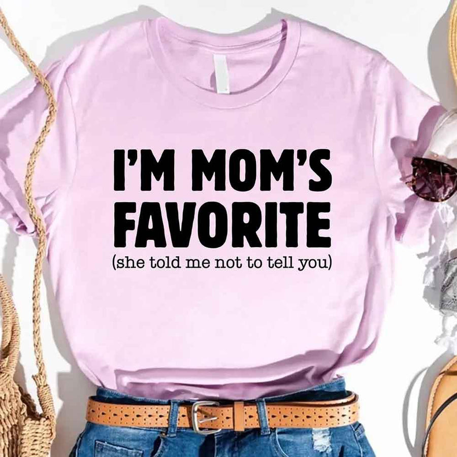 May include a unisex t-shirt reading “I’m Mom’s Favorite” in bold font, displayed on a flat lay or model, ideal for Mother’s Day gifting.