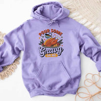 Purple hoodie with a graphic design on a textured surface