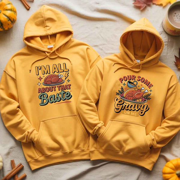 Two yellow hoodies with Thanksgiving-themed graphics on a light background.