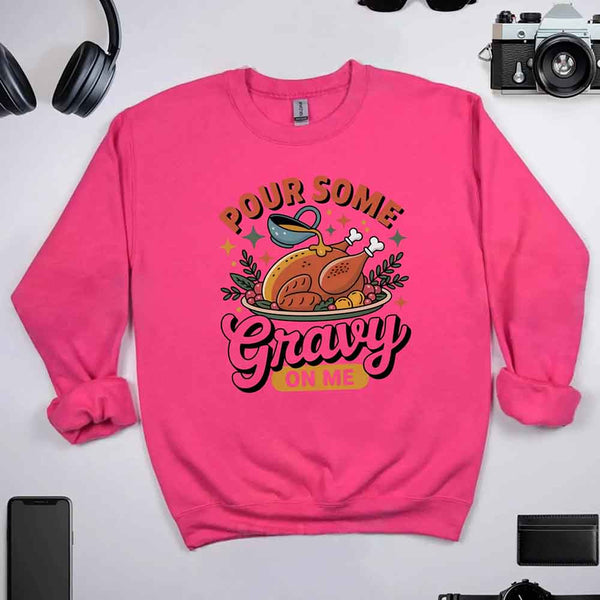Pink sweatshirt with a graphic design and text on a light gray background