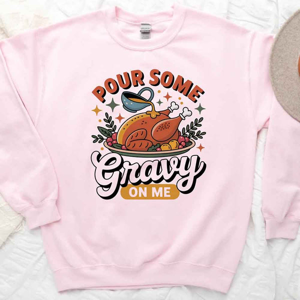 Pink sweatshirt with a graphic of a roasted turkey and text 'Pour Some Gravy On Me' on a light background.