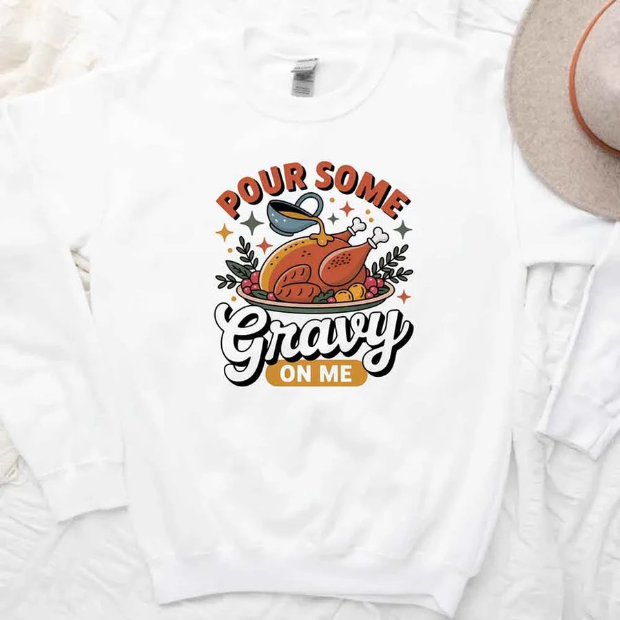 White t-shirt with a graphic of a turkey and text 'Pour Some Gravy On Me' on a white background.