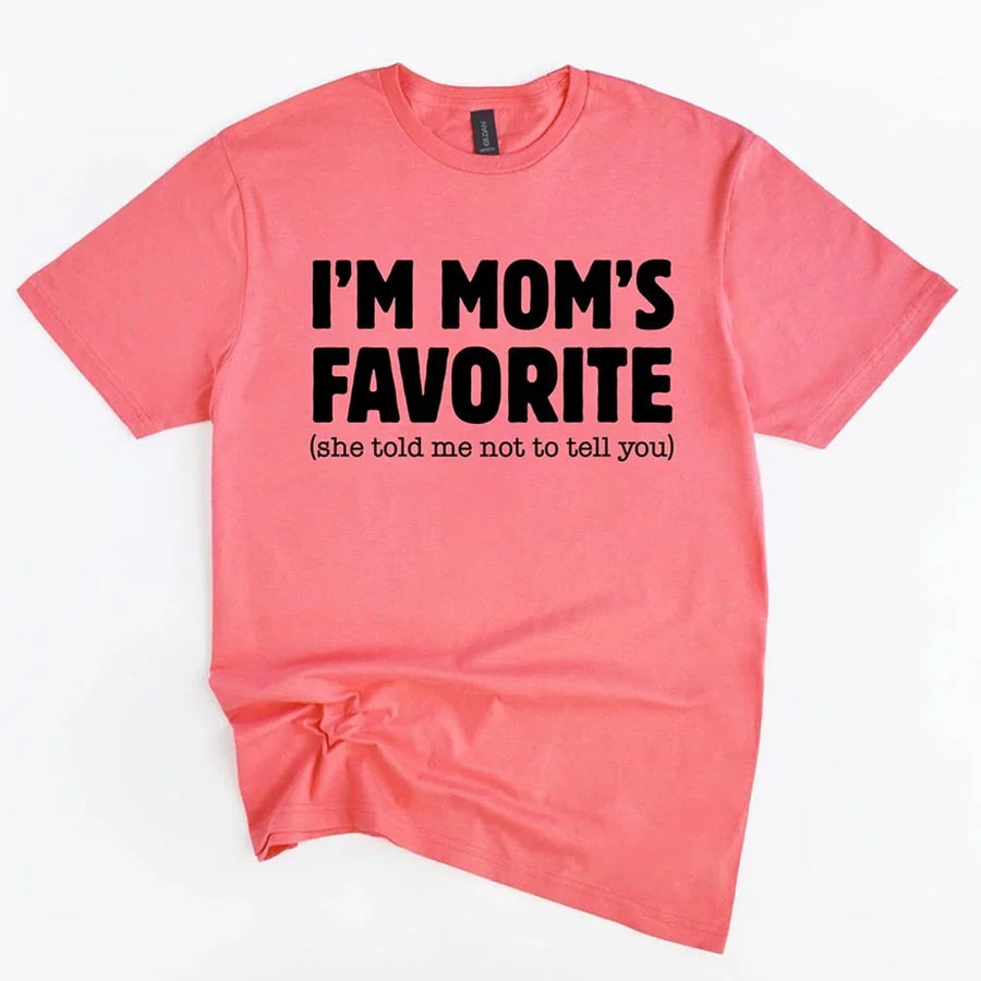 May include a unisex t-shirt reading “I’m Mom’s Favorite” in bold font, displayed on a flat lay or model, ideal for Mother’s Day gifting.