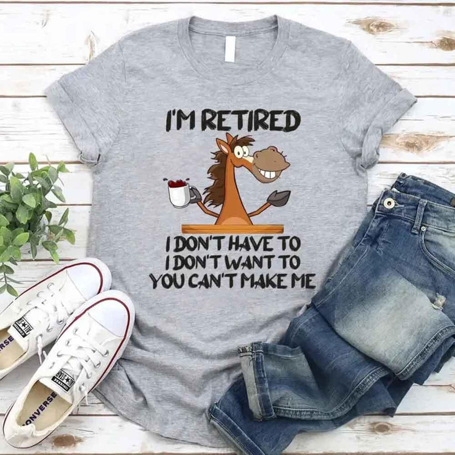 May include a graphic tee with the phrase “I Am Retired I Don’t Have To” printed in a bold, humorous style, featuring clean lettering on a casual shirt meant to highlight a playful retirement message.