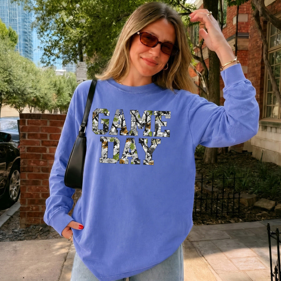May include a Game Day Camo Print Comfort Colors Unisex Long Sleeve featuring a football-inspired camo print design.